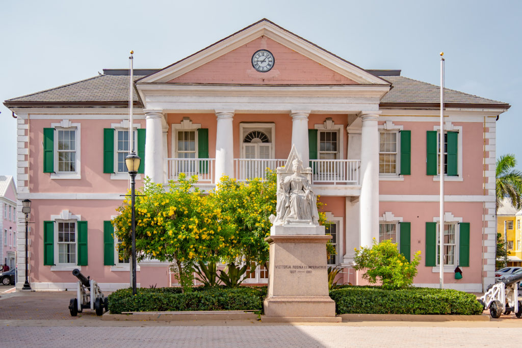 Pink house with statue of Queen Victoria in The Bahamas