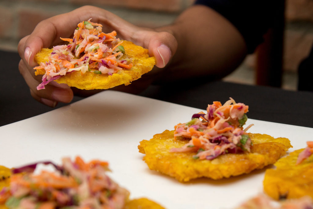Tostones with grated carrot salad, cabbage, lettuce, mayonnaise.